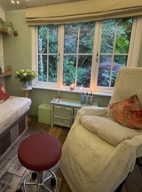 A peaceful, inside view of Jane Ford's reflexology room, showcasing a calming atmosphere with soft lighting and comfortable furnishings in Warwickshire.